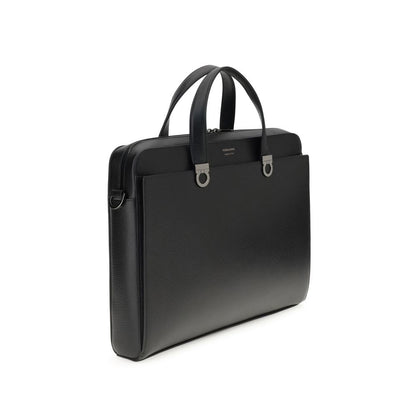 Large Briefcase by Ferragamo for men in bos taurus calf leather black & jacquard presents a contemporary silhouette from the Gancini Ribbon Bos Taurus Calf Leather Large Briefcase collection, featuring a contemporary magnetic, ample external-pockets, and versatile shoulder-strap, adjustable-strap & handle.