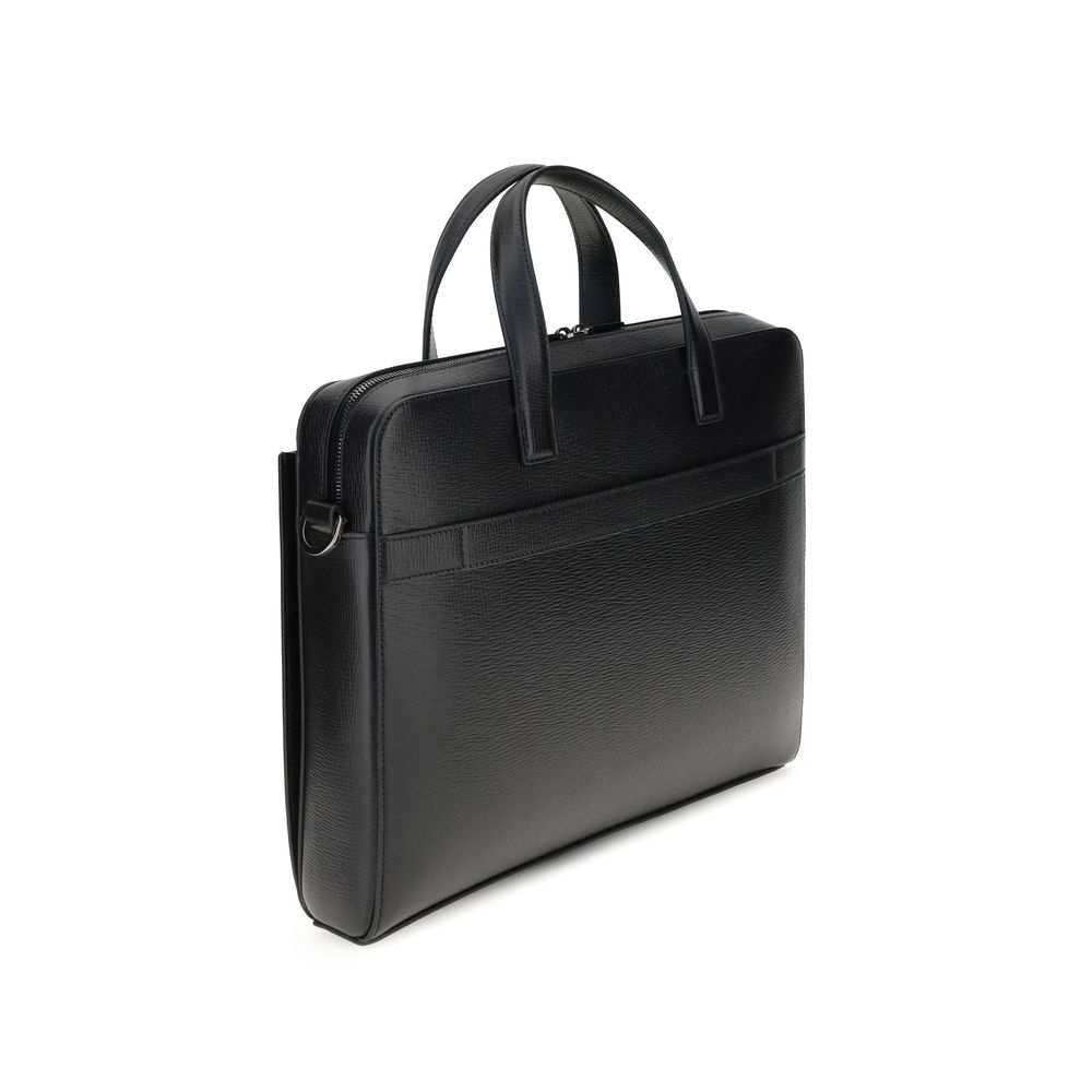 Large Briefcase by Ferragamo for men in bos taurus calf leather black & jacquard features a architectural silhouette, showcasing the Gancini Ribbon Bos Taurus Calf Leather Large Briefcase design with a secure magnetic, ample external-pockets, and versatile shoulder-strap, adjustable-strap & handle.