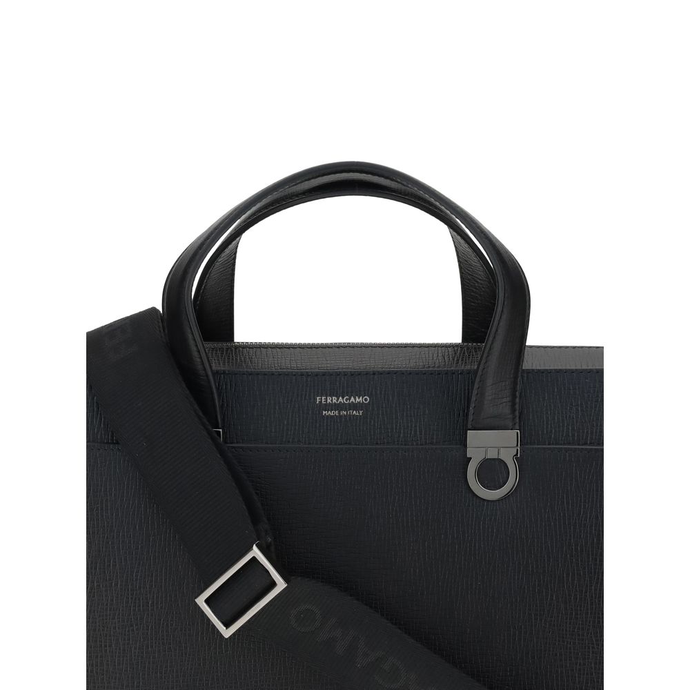 Large Briefcase by Ferragamo for men in bos taurus calf leather black & jacquard features a architectural silhouette, showcasing the Gancini Ribbon Bos Taurus Calf Leather Large Briefcase design with a secure magnetic, ample external-pockets, and versatile shoulder-strap, adjustable-strap & handle.