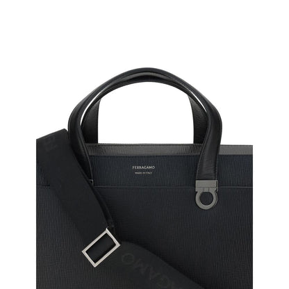 Large Briefcase by Ferragamo for men in bos taurus calf leather black & jacquard features a architectural silhouette, showcasing the Gancini Ribbon Bos Taurus Calf Leather Large Briefcase design with a secure magnetic, ample external-pockets, and versatile shoulder-strap, adjustable-strap & handle.