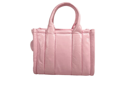 Micro Crossbody Evening Tote Handbag by Marc Jacobs for women in ostrich leather pink & silver features a multifaceted silhouette, showcasing a secure zipper and multifaceted with versatile crossbody-strap, adjustable-strap, detachable-strap & handle for multifaceted style.