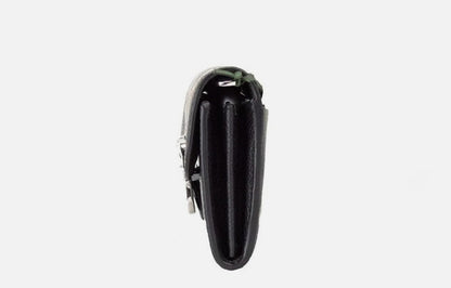 Small Crossbody Clutch Handbag by Kate Spade for women in faux patent leather black & silver presents a ornamental silhouette, showcasing a secure snap & zipper, ample cardholder, and versatile crossbody-strap & detachable-strap for a ornamental finish.