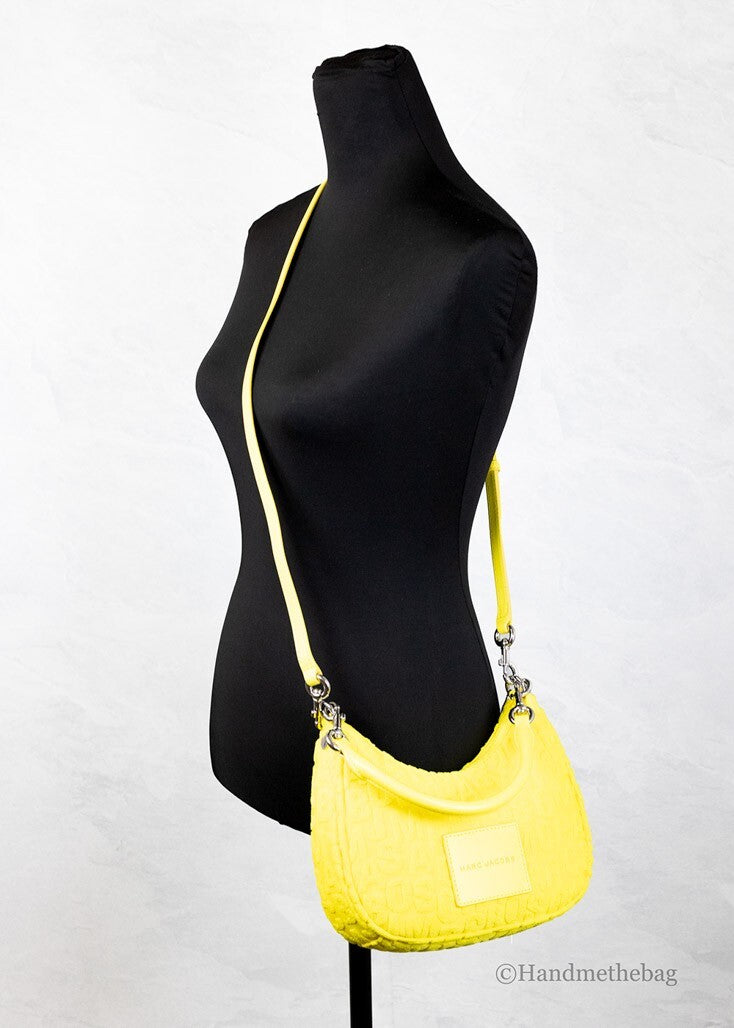 Small 2-in-1 Shoulder & Crossbody Crescent Hobo Bag by Marc Jacobs for women in polyester & nylon silver, patterned, signature & monogram presents a statuesque silhouette, showcasing a secure zipper and statuesque with versatile crossbody-strap, shoulder-strap, adjustable-strap & detachable-strap for a sophisticated look.