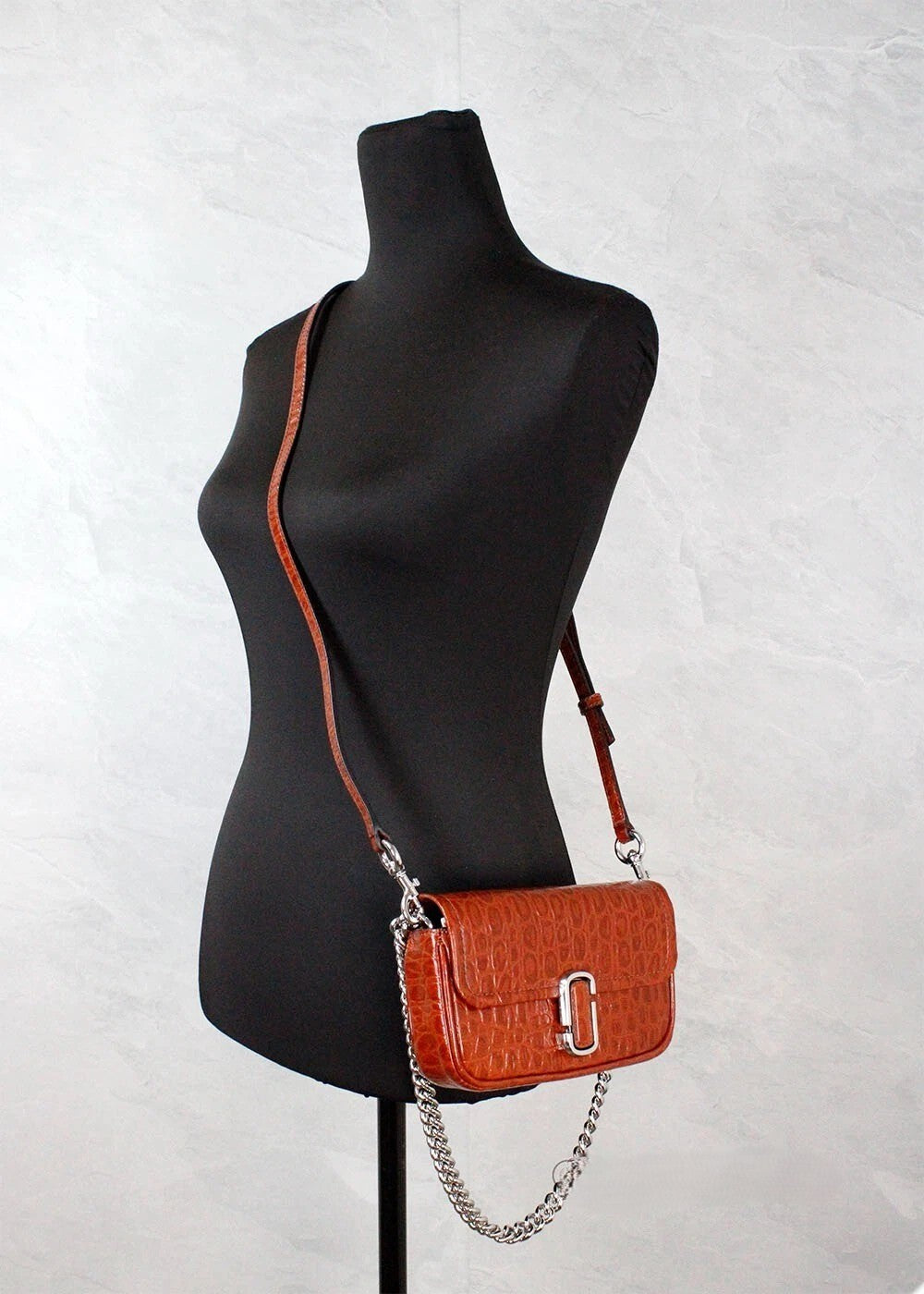 Mini 2-in-1 Shoulder & Crossbody Travel Handbag by Marc Jacobs for women in leather & metal animal, brown, silver, patterned & print features a versatile chic silhouette, meticulously detailed with a secure zipper & magnetic, ample cardholder, and versatile crossbody-strap, shoulder-strap, adjustable-strap & detachable-strap.