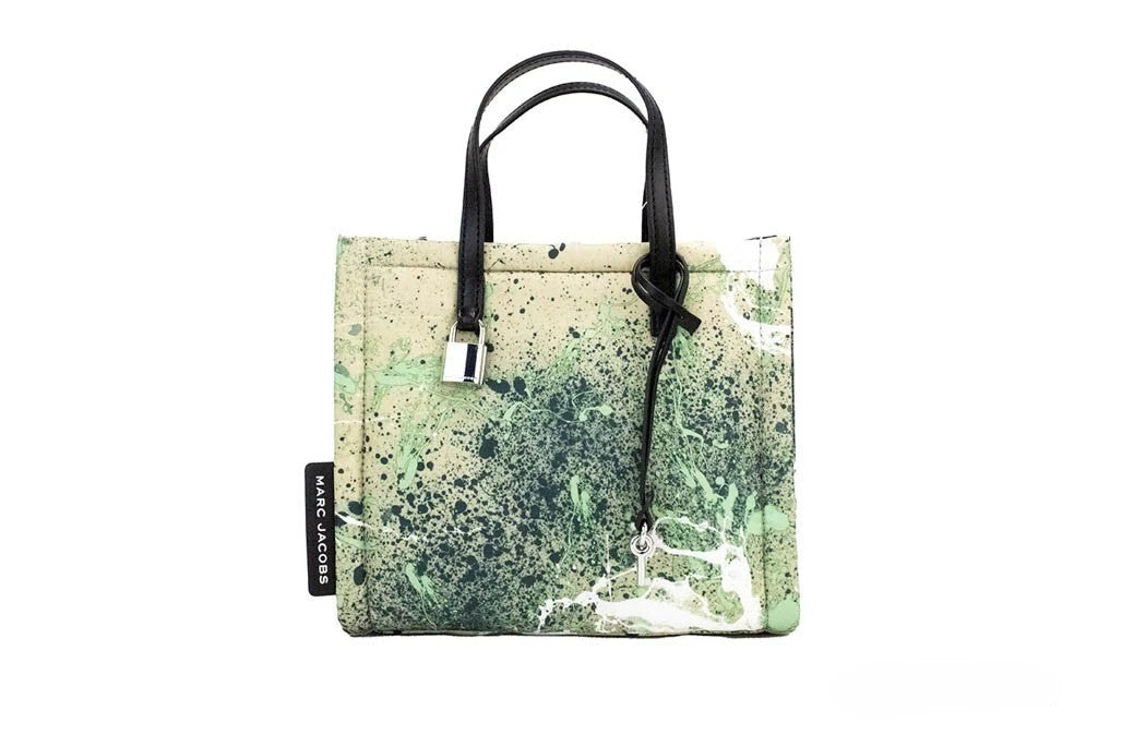 Mini Crossbody Travel Tote Handbag by Marc Jacobs for women in raffia & leather green, multicolor, silver & print features a versatile chic silhouette, meticulously detailed with a secure zipper, ample , and versatile crossbody-strap, adjustable-strap, detachable-strap & handle.