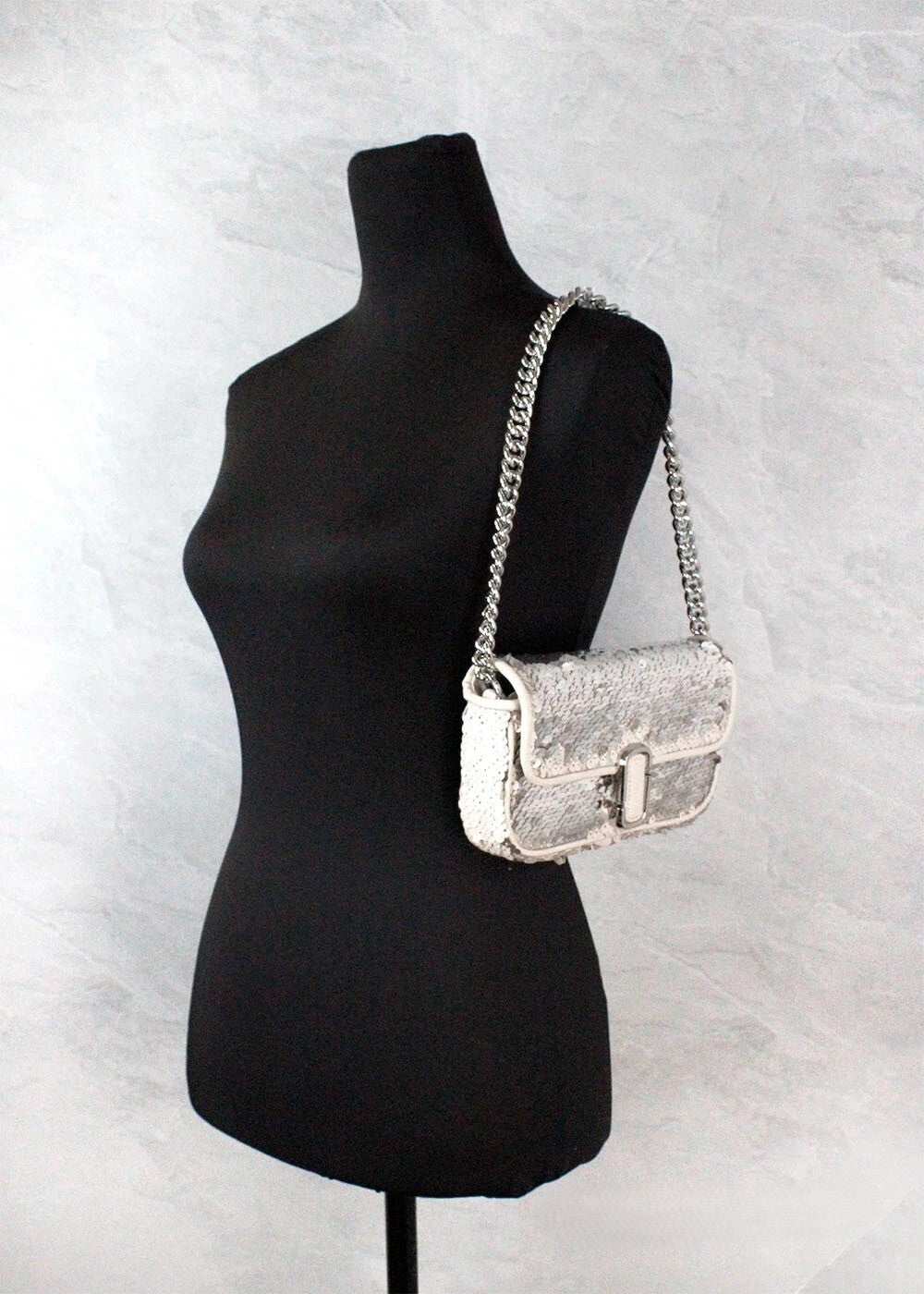 Mini 2-in-1 Shoulder & Crossbody Evening Handbag by Marc Jacobs for women in leather cream & silver features a multifaceted silhouette, showcasing a secure zipper & magnetic and multifaceted cardholder with versatile crossbody-strap, shoulder-strap & adjustable-strap for multifaceted style.
