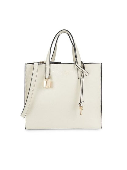 Mini Tote Bag by Marc Jacobs for women in canvas & leather black, gold, marshmallow & white showcases a statuesque Canvas & Leather Mini Tote Bag design, featuring a secure , ample , and versatile adjustable-strap, detachable-strap & handle for a statuesque finish.