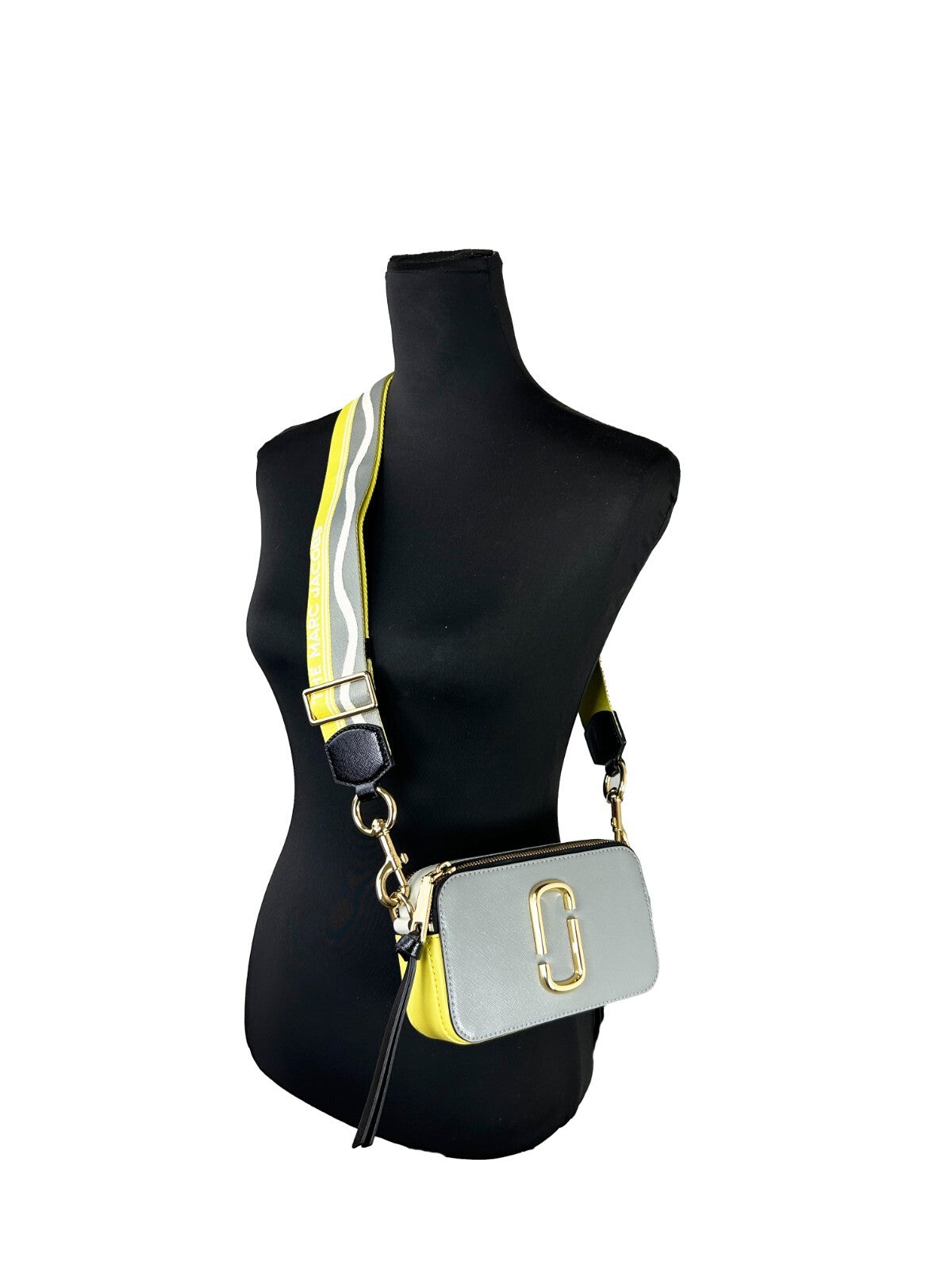 Small Crossbody Handbag by Marc Jacobs for women in canvas gold features a versatile chic silhouette, meticulously detailed with a secure zipper, ample , and versatile crossbody-strap, adjustable-strap & detachable-strap.