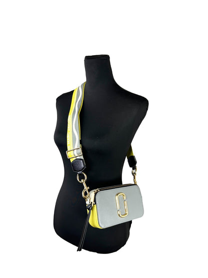 Small Crossbody Handbag by Marc Jacobs for women in canvas gold features a versatile chic silhouette, meticulously detailed with a secure zipper, ample , and versatile crossbody-strap, adjustable-strap & detachable-strap.