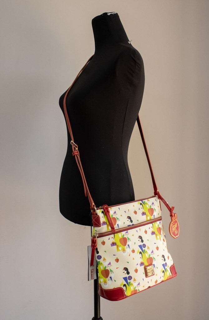 Medium Crossbody Handbag by Dooney & Bourke for women in leather cotton polyethylene gold, orange, red, white & patterned features an multi-faceted design with a secure , ample , and versatile crossbody-strap & adjustable-strap for a multi-faceted finish.