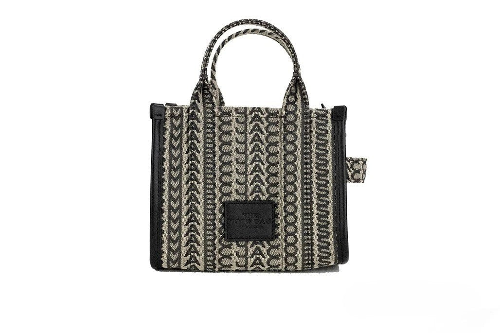 Mini Crossbody Travel Tote Handbag by Marc Jacobs for women in calfskin leather & nylon beige, silver, patterned, jacquard & monogram features an multi-faceted design with a secure zipper, ample cardholder, and versatile crossbody-strap, adjustable-strap, detachable-strap & handle for a multi-faceted finish.