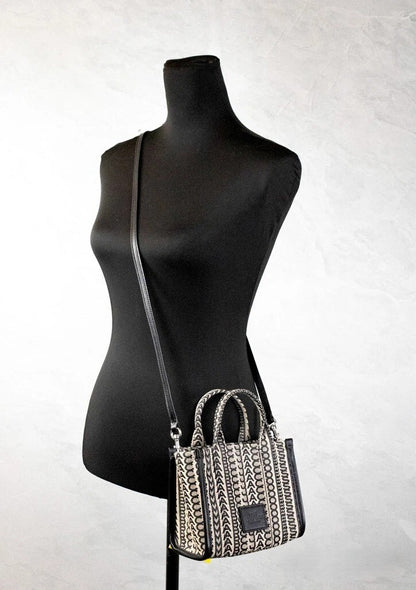 Mini Crossbody Travel Tote Handbag by Marc Jacobs for women in calfskin leather & nylon beige, silver, patterned, jacquard & monogram features a transformative elegance silhouette, showcasing a secure zipper, organized cardholder, and versatile crossbody-strap, adjustable-strap, detachable-strap & handle for a transformative elegance look.