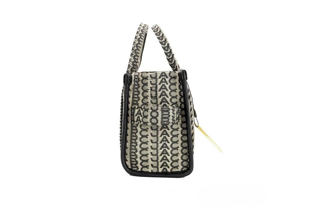 Mini Crossbody Travel Tote Handbag by Marc Jacobs for women in calfskin leather & nylon beige, silver, patterned, jacquard & monogram features a multifaceted silhouette, showcasing a secure zipper and multifaceted cardholder with versatile crossbody-strap, adjustable-strap, detachable-strap & handle for multifaceted style.