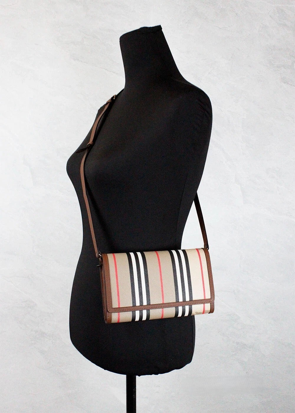 Medium Crossbody Travel Handbag by Burberry for women in canvas beige, gold, tan, patterned & striped features a transformative elegance silhouette, showcasing a secure snap, organized , and versatile crossbody-strap & adjustable-strap for a transformative elegance look.