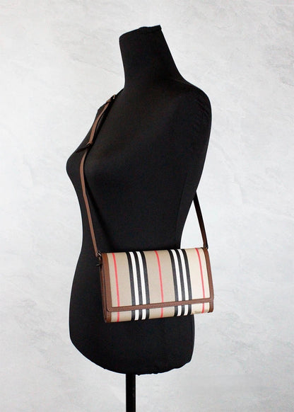 Medium Crossbody Travel Handbag by Burberry for women in canvas beige, gold, tan, patterned & striped features a transformative elegance silhouette, showcasing a secure snap, organized , and versatile crossbody-strap & adjustable-strap for a transformative elegance look.
