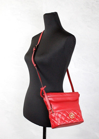 Small Quilted Crossbody Bucket Handbag by Versace for women in leather gold & red features a signature silhouette, showcasing a secure drawstring and signature with versatile crossbody-strap, shoulder-strap & adjustable-strap for a sophisticated look.