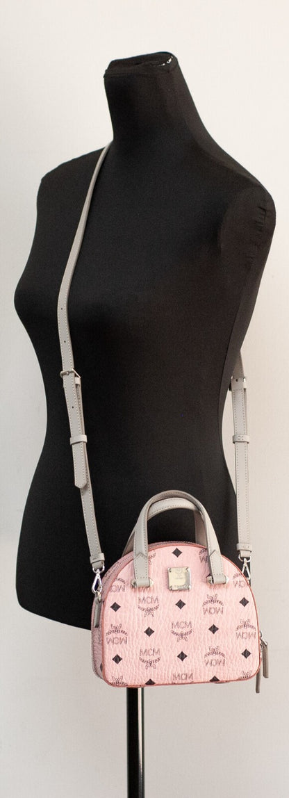 Compact Half Moon Crossbody Handbag by MCM for women in leather pink, silver & signature features a transformative elegance silhouette, showcasing a secure zipper, organized cardholder, and versatile crossbody-strap, handle, adjustable-strap & detachable-strap for a transformative elegance look.