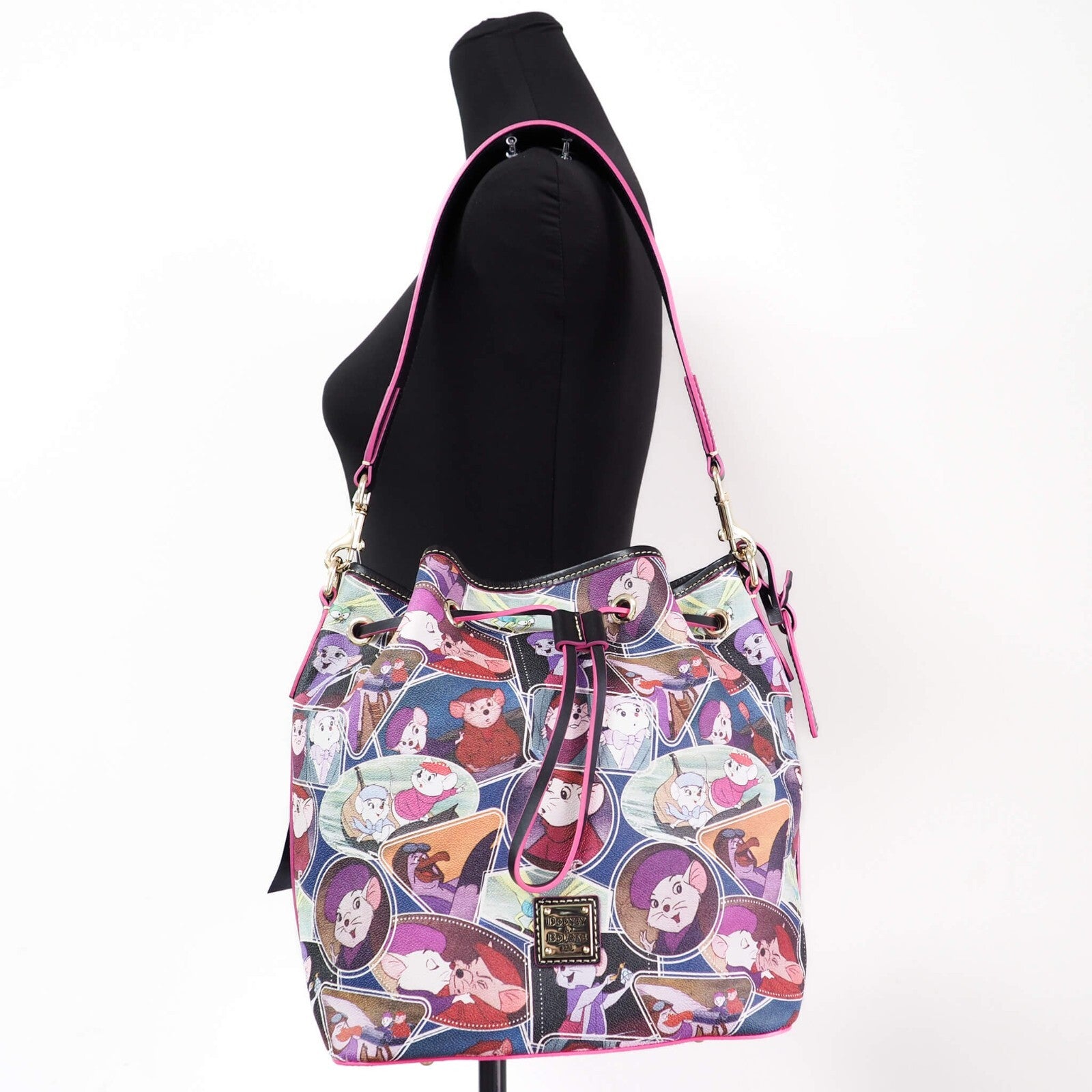 Shoulder Bucket Bag by Dooney & Bourke for women in coated canvas gold & multicolor showcases a statuesque silhouette, artfully detailed with a secure zipper & drawstring, organized , and versatile shoulder-strap & detachable-strap for a statuesque look.