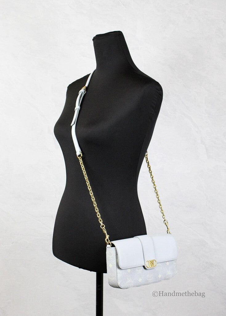 Small Crossbody Clutch Handbag by MCM for women in pebbled leather gold features a statuesque silhouette, showcasing a secure zipper and organized cardholder with versatile crossbody-strap, adjustable-strap & detachable-strap for statuesque evening wear.