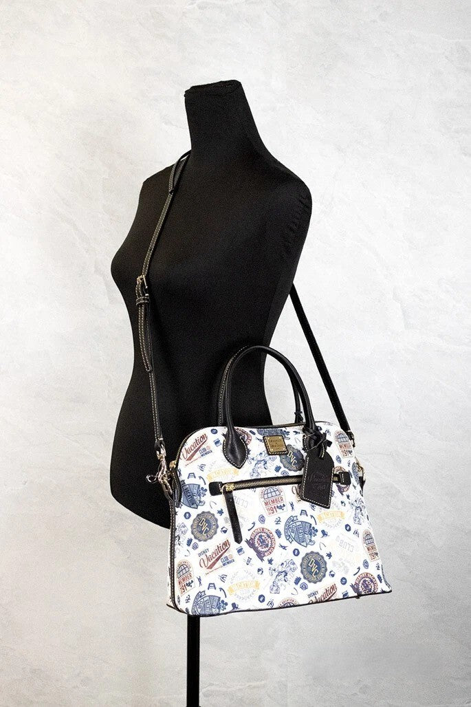 Crossbody Crescent Satchel Handbag by Dooney & Bourke for women in cotton polyester canvas gold features a transformative elegance silhouette, showcasing a secure zipper, organized , and versatile crossbody-strap, adjustable-strap, detachable-strap & handle for a transformative elegance look.