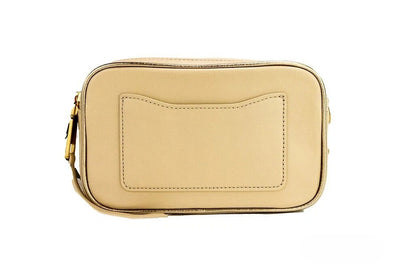 Travel Crossbody Camera Handbag by Marc Jacobs for women in leather beige, gold & ivory features an multi-faceted design with a secure zipper, ample built-in-compartments, and versatile crossbody-strap, adjustable-strap & detachable-strap for a multi-faceted finish.