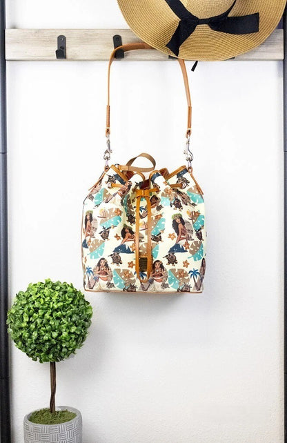 Medium Crossbody Bucket Handbag by Dooney & Bourke for women in cotton polyester canvas brown, gold & print features a transformative sophistication silhouette, showcasing a secure zipper & drawstring, ample , and versatile crossbody-strap, shoulder-strap, handle, adjustable-strap & detachable-strap for a transformative sophistication look.
