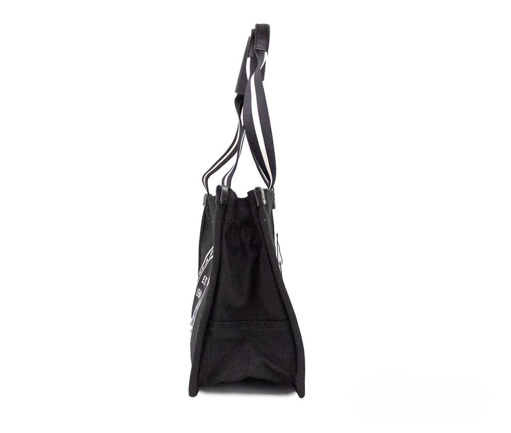 Medium Travel Tote Shoulder Bag by Marc Jacobs for women in canvas black & silver features a statuesque silhouette, showcasing a secure zipper and statuesque with versatile handle for a statuesque finish.