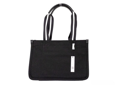 Medium Travel Tote Shoulder Bag by Marc Jacobs for women in canvas black & silver features a effortless sophistication silhouette, secured by a zipper with ample and versatile handle for a effortless sophistication finish.