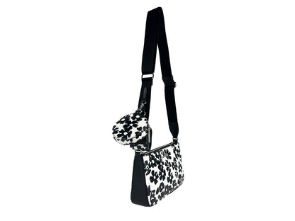 Small Crossbody Travel Pouch Handbag by Michael Kors for women in leather black, silver, patterned & floral features a ornamental silhouette, showcasing a secure zipper, ample cardholder & coin-purse, and ornamental crossbody-strap, adjustable-strap & detachable-strap for a sophisticated look.