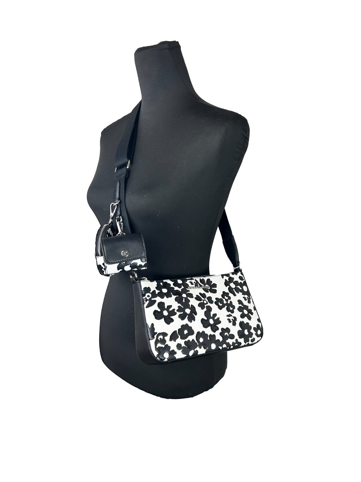 Small Crossbody Travel Pouch Handbag by Michael Kors for women in leather black, silver, patterned & floral features a exquisite silhouette, showcasing a secure zipper and exquisite cardholder & coin-purse with versatile crossbody-strap, adjustable-strap & detachable-strap for a exquisite finish.
