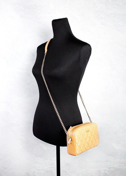 Mini Quilted Travel Camera Crossbody Handbag by Kate Spade for women in leather brown & gold features an multi-faceted design with a secure zipper, ample , and versatile crossbody-strap & adjustable-strap for a multi-faceted finish.