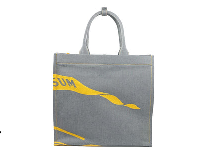 This Pouch Tote Handbag by Burberry for women in faux leather & canvas and gray, silver & patterned presents a sculptural silhouette featuring a secure , ample coin-purse, and versatile handle for a sculptural finish.