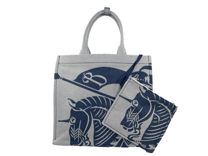 Pouch Tote Handbag by Burberry for women in calfskin leather & nylon gray, navy & silver features an refined silhouette, showcasing a secure , ample coin-purse, and versatile for a sophisticated refined aesthetic.