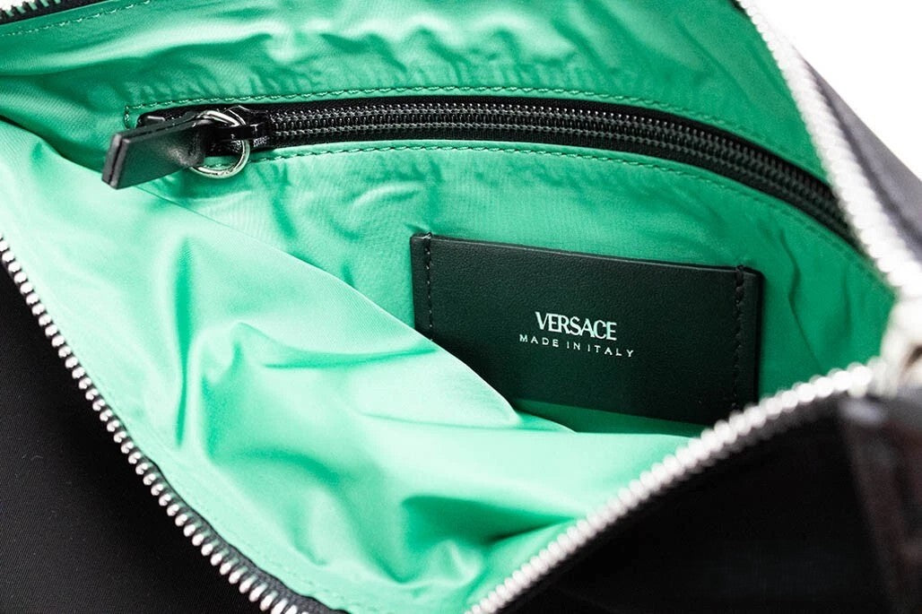Large Travel Wristlet Clutch Handbag by Versace for women in lyocell black, green & silver features a statuesque silhouette, showcasing a secure zipper and organized with versatile wristlet & detachable-strap for statuesque evening wear.