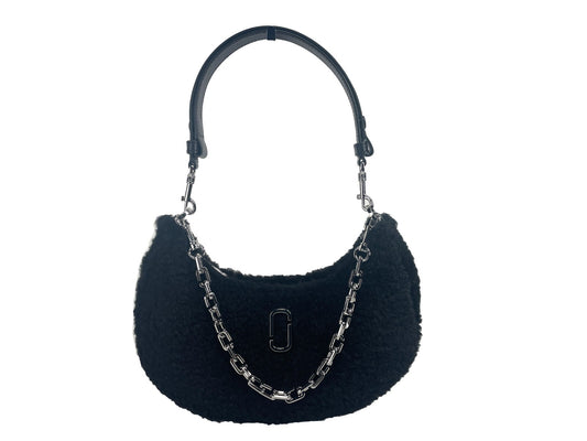This Medium Crossbody Travel Tote Handbag by Marc Jacobs for women in faux polyester fur and black & silver presents a sculptural silhouette featuring a secure zipper, ample , and versatile crossbody-strap, detachable-strap & handle for a sculptural finish.