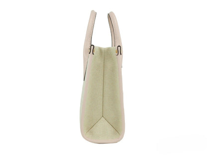 This Small Crossbody Evening Shopper Handbag by Michael Kors for women in canvas and beige & gold presents a sculptural silhouette featuring a secure zipper, ample , and versatile crossbody-strap, adjustable-strap & detachable-strap for a sculptural finish.