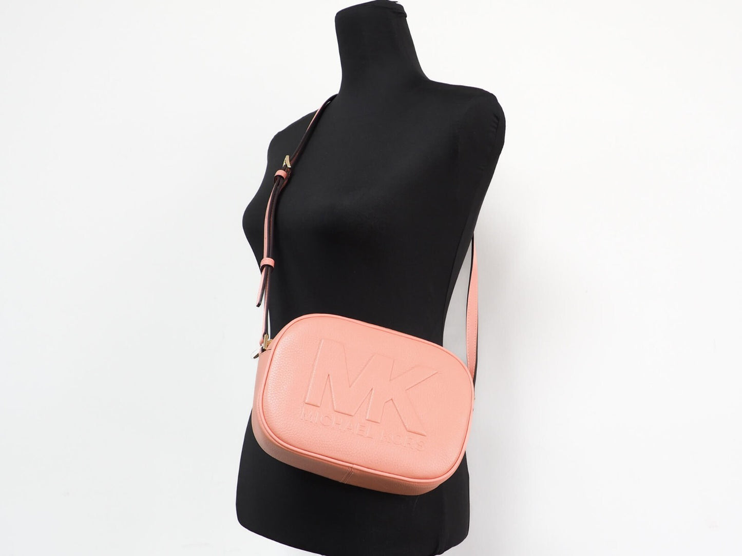 Medium Travel Crossbody Camera Handbag by Michael Kors for women in pebbled leather gold features a ornamental silhouette, showcasing a secure , ample , and ornamental crossbody-strap & adjustable-strap for a sophisticated look.