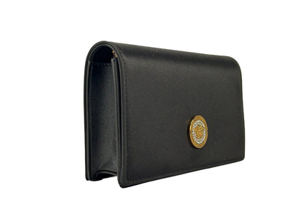Mini Crossbody Handbag by Versace for women in leather black & gold features a versatile chic silhouette, meticulously detailed with a secure snap & button, ample cardholder, and versatile crossbody-strap.