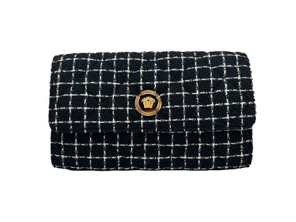 Crossbody Handbag by Versace for women in leather black & gold features a multifaceted silhouette, showcasing a secure snap & button and multifaceted cardholder with versatile crossbody-strap for multifaceted style.