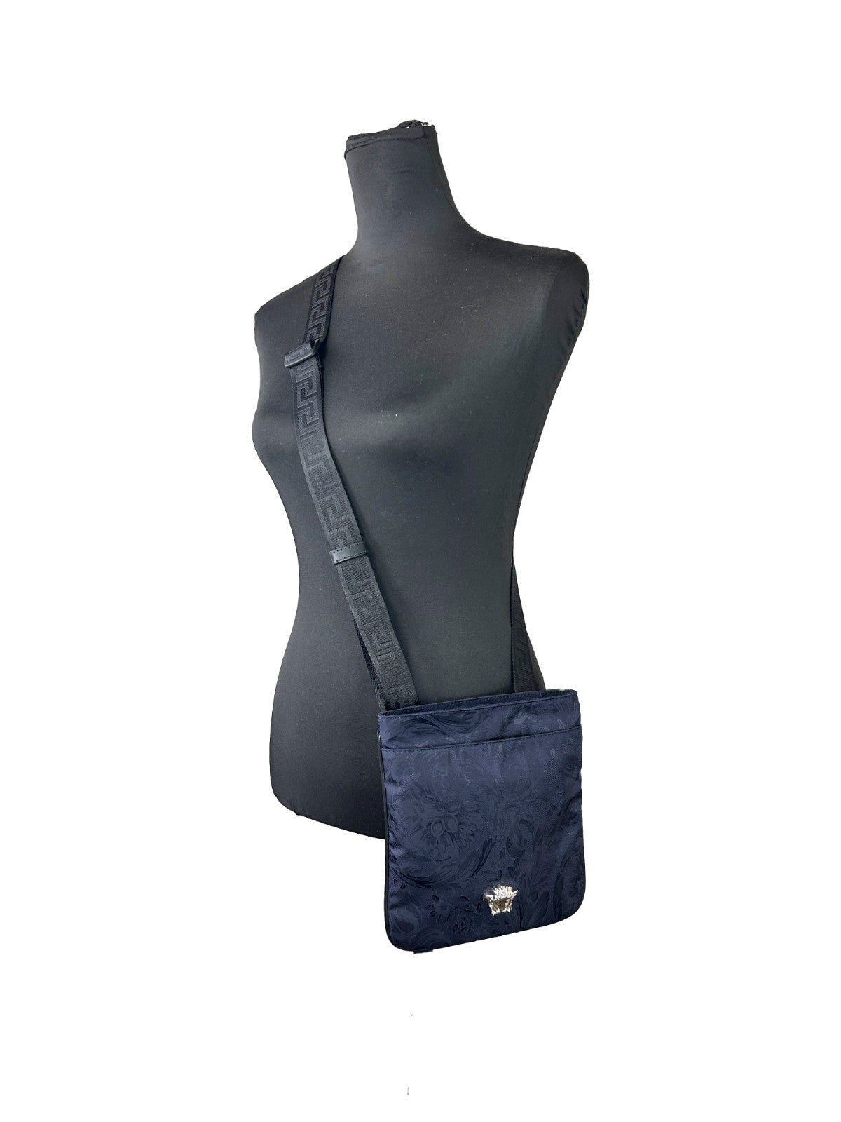 Crossbody Handbag by Versace for women in calfskin leather & nylon navy & silver features a versatile chic silhouette, meticulously detailed with a secure , ample , and versatile crossbody-strap & adjustable-strap.