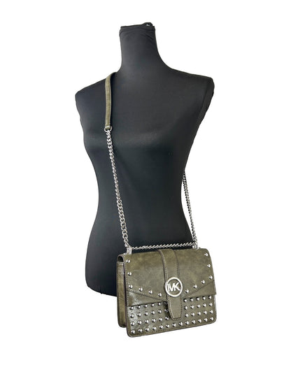 Small Crossbody Flap Handbag by Michael Kors for women in leather green, olive & silver features a versatile chic silhouette, meticulously detailed with a secure flap & magnetic, ample , and versatile crossbody-strap.