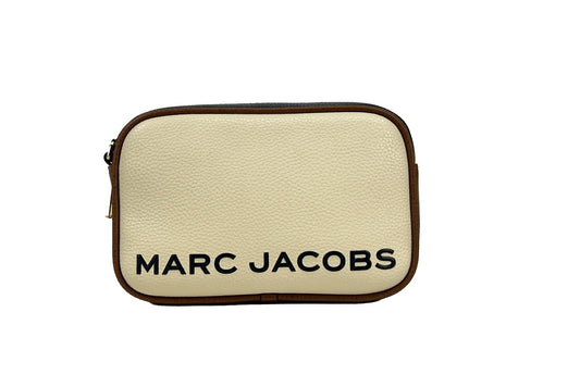 Crossbody Camera Handbag by Marc Jacobs for women in leather gold & marshmallow features a multifaceted silhouette, showcasing a secure zipper and multifaceted cardholder with versatile crossbody-strap, adjustable-strap & detachable-strap for multifaceted style.