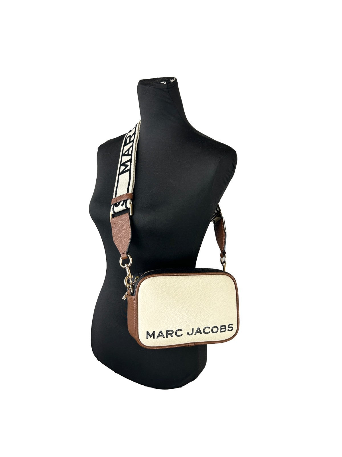 Crossbody Camera Handbag by Marc Jacobs for women in leather gold & marshmallow features a transformative elegance silhouette, showcasing a secure zipper, organized cardholder, and versatile crossbody-strap, adjustable-strap & detachable-strap for a transformative elegance look.