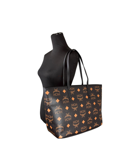 Tote Bag by MCM for women in leather black, silver, signature-print & print features a jet-set Aren Leather Tote Bag design, complete with a secure , ample , and versatile for a jet-set look.