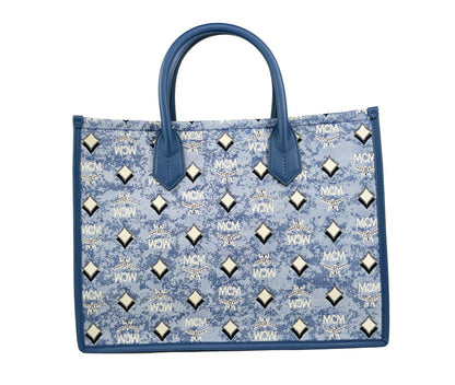 This Tote Bag by MCM for women in cotton polyester canvas blue, silver, signature-print & print features an jet-set Aren Cotton Polyester Canvas Tote Bag design with a secure , ample , and jet-set .