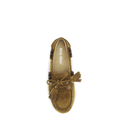 Flat Boat Loafer Slip-On Shoes by Miu Miu for women in bos taurus calf suede leather beige features an ergonomic silhouette, perfectly showcasing Women's Bos Taurus Calf Suede Leather Flat Boat Loafer Slip-On Shoes with its distinct flat and elegant .