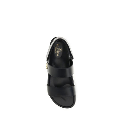 Flat Sandals by Valentino Garavani for men in bos taurus calfskin leather black, gold & signature presents a sculptural silhouette, showcasing the V Logo Men's Bos Taurus Calfskin Leather Flat Sandals design with a sculptural flat and for a premium look.