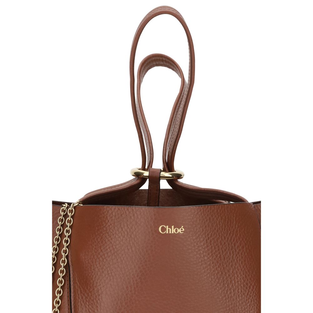 Shoulder Bag by Chloé for women in bos taurus calf grained leather brown & monogram showcases a enviable silhouette, artfully detailed with a secure , organized single-compartment, and versatile shoulder-strap & handle for a enviable look.