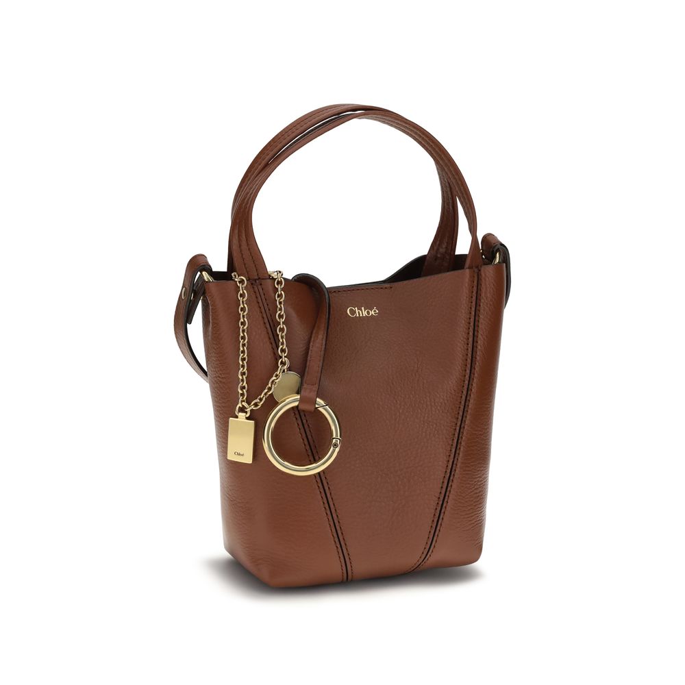 Shoulder Bag by Chloé for women in bos taurus grained leather brown & monogram showcases a enviable silhouette, artfully detailed with a secure magnetic & button, organized single-compartment, and versatile shoulder-strap, handle & adjustable-strap for a enviable look.
