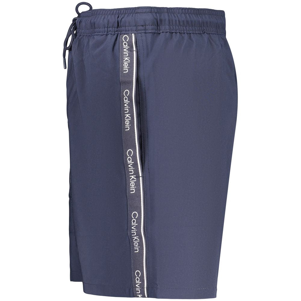 Swim Shorts by Calvin Klein for men in stretch polyester and blue showcases a sinuous silhouette, expertly cut for a sinuous fit as part of the Waves Men's Stretch Polyester Swim Shorts collection.